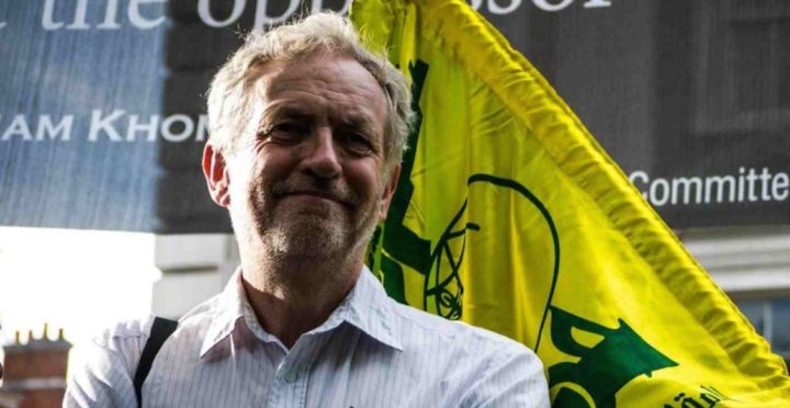 Corbyn in front of Hezbollah flag
